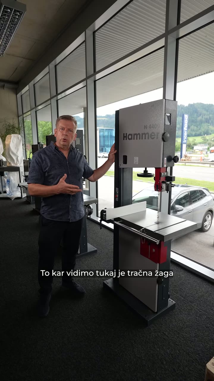 The opening seconds of the delivered vertical presentation for a machine-dealer commercial shoot: the presenter beside two bandsaws, Slovenian captions burned in — the finished result cut from take 04.